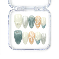 Naillover Oceanic Floral Breeze handmade press on nails with blue-green and beige tones, floral art, shell textures, glitter, and pearl accents — elegant Singapore press on nails.