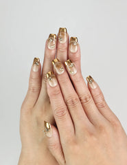 Close-up of Opal Vibe Singapore press on nails with beige base and gold contour, worn for an elegant everyday look