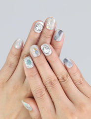 Wearing Naillover Opal Whisper press on nails—short smoky grey nails with gold shimmer accents.