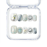 Naillover Opal Whisper handmade short press on nails in smoky grey with gold and pastel detailing from the Singapore press on nails collection.