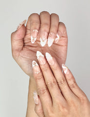 Elegant Naillover Peach Petal press on nails worn on hand, showcasing sculpted 3D flowers and delicate pearl details.