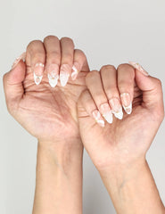 Naillover Peach Petal Singapore press on nails styled on hand, highlighting golden gem accents and floral artistry.