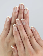 Model wears Pearl Glow press on nails — nude shade with pearly finish, handcrafted by Naillover in Singapore.