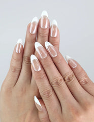 Model showcasing Naillover Pearly Shine nails — white almond-shaped handmade press ons with a pearlescent glow.