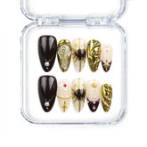 Regal Radiance handmade Singapore press on nails by Naillover featuring deep burgundy base, gold accents, and pearl details for a luxurious, classic style