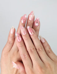 Model hand with Sakura press on nails, showing soft pink base and 3D cherry blossom flowers, styled for a fresh and cute nail look.