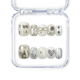 Naillover handmade press on nails in crisp white with silver bow and stud accents, a Singapore press on nails design in a classic short square shape.