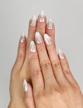 Model wearing Naillover Silver Gleam handmade press on nails Singapore with rhinestone details on white base.