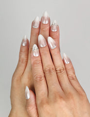 Model wearing Naillover Silver Gleam handmade press on nails Singapore with rhinestone details on white base.