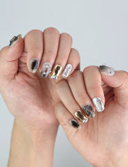 Styled hand pose featuring Naillover Smoky Metal Rush — futuristic metallic gray press on nails for bold, trendy nail lovers.