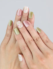 Wearing Naillover Spring Buds press on nails featuring pastel gradients and floral designs—perfect for a spring-inspired manicure.