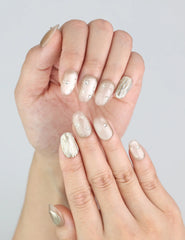 Close-up of Naillover Starlet Shine handmade press on nails—elegant nude tones with soft gold accents.