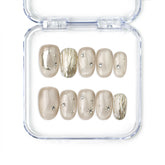 Naillover Starlet Shine handmade press on nails with champagne nude tones and fine gold thread detailing from the Singapore press on nails line.