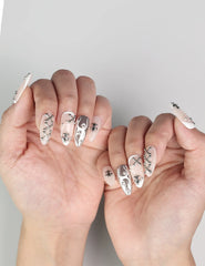 Elegant hand pose with Subtle Knots handmade Singapore press on nails featuring minimalist metallic accents