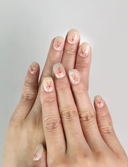 Model wearing Naillover Sweet Bow handmade press on nails, white nails with red bow design, cute nails Singapore