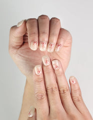 Close-up of Sweet Bow handmade press on nails by Naillover, white nails with delicate red bows, trendy nails SG