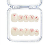 Sweet Bow handmade press on nails from Naillover, featuring white nails with red bow design, Singapore press on nails