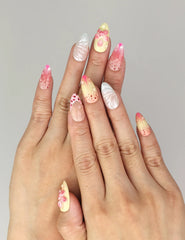 Model wearing Naillover Sweet Pink Yellow 3D Floral Droplet Singapore press on nails with playful pink-yellow blossoms