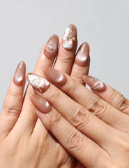 Wearing Tangerine Daisy Shine earthy tangerine handmade press on nails with white daisies and gold shimmer by Naillover Singapore.