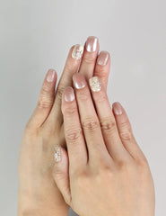 Model wearing Warm Petal handmade Singapore press on nails with pink-to-white ombre and crystal rhinestone details