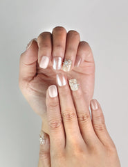 Close-up of Warm Petal Singapore press on nails by Naillover showing ombre pink-to-white fade and sparkling crystal accents