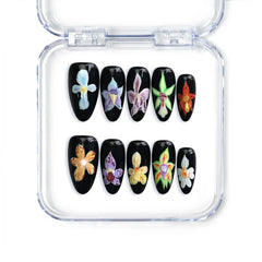 Night Petals almond press-on nails featuring black bases and iris flower art, handmade in Singapore by Naillover.