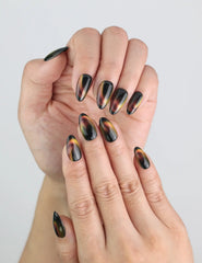 Close-up hand model wearing Noir Fade Tips black cat eye press-on nails with French fade from naillover Singapore collection.