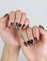 Hand posed naturally wearing Noir Fade Tips black cat eye press-on nails, handmade from Singapore press on nails collection.