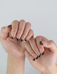 Naillover Nude Edge handmade press on nails styled on hand, highlighting bold black tips and elegant shine.