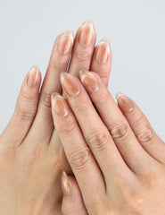 Hand modeling Naillover Nude Fade Tips with soft beige cat eye shine, short press on nails.