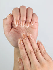 Close-up of Nude Fade Tips handmade nails by Naillover, reverse French cat eye design.