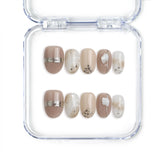 Naillover handmade Singapore press on nails featuring nude and gold design in short oval shape