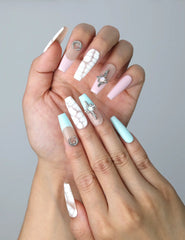Close-up of Naillover’s handmade Singapore nails with white crackle effects and shimmering celestial art