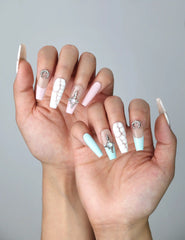 Side view of dreamy pastel coffin nails featuring cosmic accents, soft tones, and a cracked marble finish