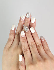 Model wearing Pearl Sparkle pearly white press-on nails with pearls and silver gemstones, Singapore handmade nails by naillover