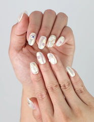 Close-up of Naillover’s handmade nails featuring sparkling gems and 3D pearls on a glossy base