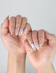 Side view of almond press-on nails in dreamy pastel colors with intricate white flower designs