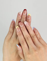 Close-up of Rainbow Tips Singapore press on nails by naillover, colorful glitter tips in blue, yellow, and red for a playful summer manicure.