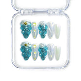 Handmade blue almond press on nails with 3D shell textures and gold starfish, from Singapore brand Naillover