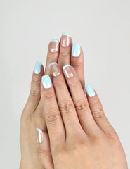 Model wearing Skyline ombre blue Singapore press on nails with sheer-to-blue glossy gradient, handmade by naillover