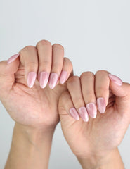 Model styling Soft Mirage pink cat eye nails from Naillover, subtle and elegant finish.