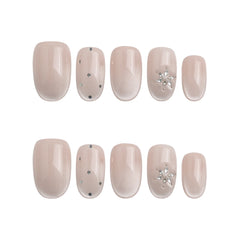 Product display of Naillover’s handmade Singapore press-on nails in nude with crystal and glitter speck pattern