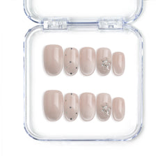 Handmade short oval press on nails in nude with crystal and glitter specks from Singapore brand Naillover