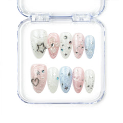 Naillover Starry Sweet Dream handmade press on nails with pearlescent pink, blue, and white base, decorated with 3D stars, pearls, heart, and rhinestones.