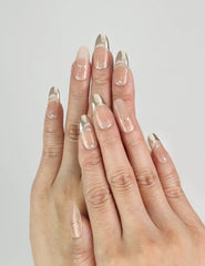 Hand wearing Sunrise Hue gradient Singapore press on nails, peach to gold glossy finish – naillover