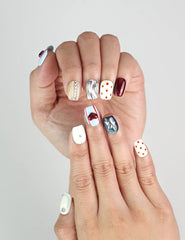 Close-up of Vibrant Pop handmade press-on nails in Singapore featuring playful red lips and silver button details.