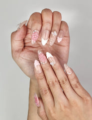 Close-up of Naillover Whispering Petals in Pink Haze Singapore press on nails showing delicate pink floral and butterfly 3D details.