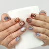 Amber Glow handmade Singapore press on nails styled while holding a cup, glossy amber gradient shine
