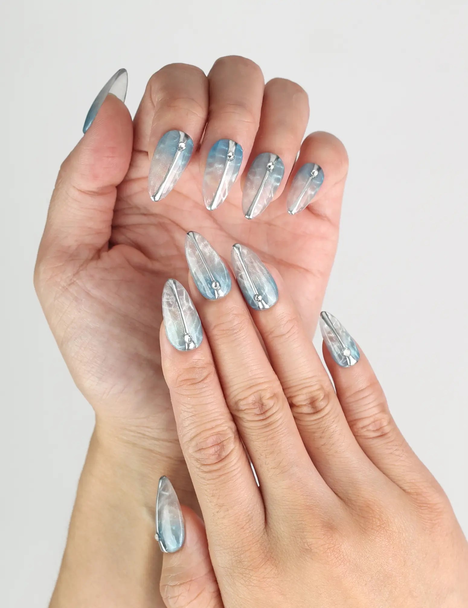 Close-up of Aqua Wave handmade press on nails showing translucent base and delicate details