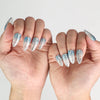 Model showcasing Aqua Wave trendy nails with summer beach background